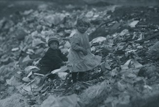 Two children going through the "Dumps." Location 1912