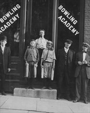 Two of the "pin boys" working in Bowling Academy with 3 other small boys until 10 or 11 P.M. some nights. 1910