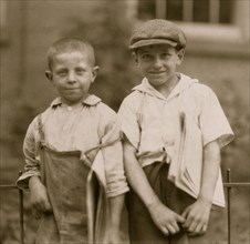 Two of the youngest newsboys in Hartford, Connecticut. They are cousins eight and ten years old. August 25, 1924. 1924
