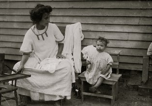 Mother & Children doing typical  home work on underwear 1912