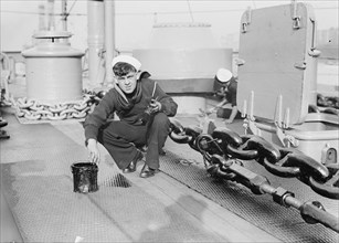 US Sailor paints the deck of the Battleship Connecticut 1912