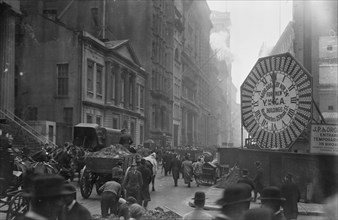 Wagons trundle along Manhattan Streets past a YMCA clock sign