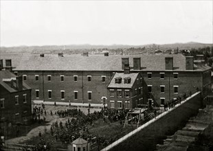 Washington, D.C. Execution of the conspirators: scaffold in use and crowd in the yard, seen from the roof of the Arsenal 1865