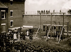 Washington, D.C. Hanging hooded bodies of the four conspirators; crowd departing 1865