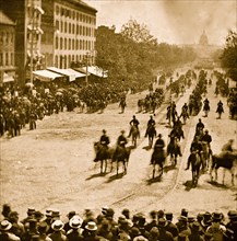 Washington, D.C. Mounted officers and unidentified units passing on Pennsylvania Avenue near the Treasury 1865