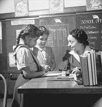 Washington, D.C. Teacher helping pupils in Black grammar school 1942