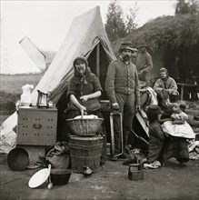 Washington, District of Columbia. Tent life of the 31st Penn. Inf. (later, 82d Penn. Inf.) at Queen's farm, vicinity of Fort Slocum; husband and wife with Children and a baby; wife does wash 1861