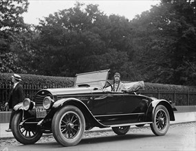 Woman wearing native American clothing in automobile 1923