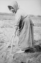 Woman with shovel in Belgian Field