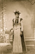 Young African American woman, full-length portrait, standing 1880