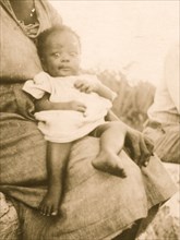 Young baby held by mother, Old Bight, Cat Island, Bahamas 1935