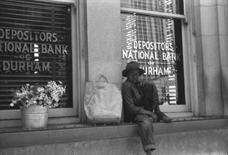 Young Black flower vendor, Durham, North Carolina 1940