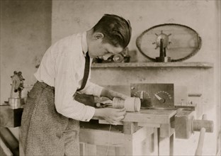 Boy at work on coil. 1924