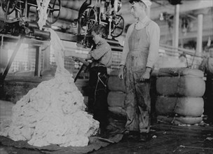 Young boy on warping machine Elk Cotton Mills. 1910