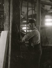 Young boy running machine in Vermont Marble Co., Centre Rutland, VT 1910