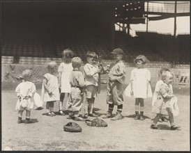 Young boys and girls on the baseball field at a major league stadium 1930