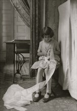 Young Girl cuts lace in here tenement apartment 1924