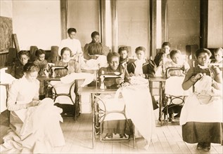 Young women sewing with machines and by hand in the sewing class at the Agricultural and Mechanical College, Greensboro, N.C. 1899