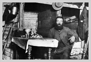 Man Sits at Table 1890