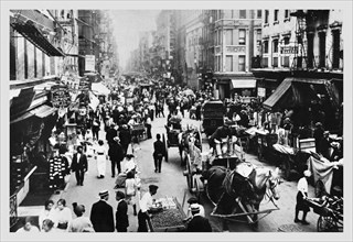 People, Peddlers, and Horse-Drawn Carriages on a Lower East Side Street 1900