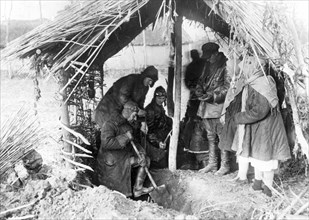 Kolkhoz (collective farm) workers discover a cache of rotting wheat hidden near a kulak (rich peasant)'s house, kurgansky region, soviet union, 1932.