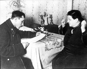 A revenue inspector interviewing a private business woman in 1926 during new economic policy period.