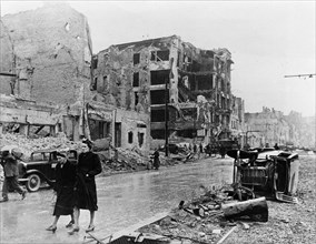 Berlin residents walk through the ruins of the city after the city was taken by the soviet red army, may 1945, world war 2.