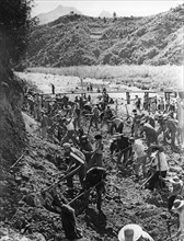 People's liberation army on a visit to the huangshantung brigade in kwangtung province work with commune members to dig a canal, november 1968, china, cultural revolution.