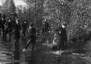 World war 2, byelorussian partisans making their way through forests and marshes.