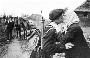 World war 2, a russian partisan in the leningrad region kissing his mother good-bye before leaving with his detachment.