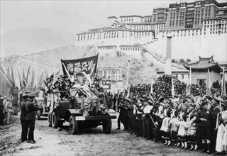 Chinese people's republic invasion of tibet, 1954, the chinese authority stage a parade in lhasa, december 25th, 1954, potala palace (home of the dalai lama) in the background.