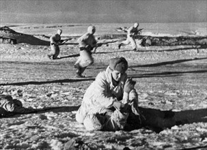 World war 2, battle of stalingrad, a medic rendering first aid to a wounded red army man northwest of stalingrad, january 1942.