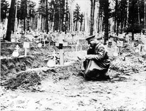 A soldier sitting at a cemetery during world war i, the czarist government, believing the war would be short, had only 4 months of supplies on hand, in spring and summer of 1915 the russian army suffe...