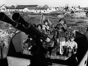 Members of the bach dang shipyards militia with their anti-aircraft gun, defending their workplace against american air attack, north vietnam, 1969.