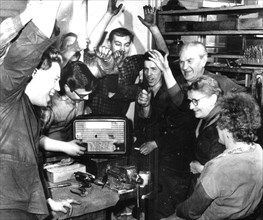 The workers of the ckd sokolovac engineering works in prague listening to the first news of soviet cosmonaut yuri gagarin's flight, 1961.