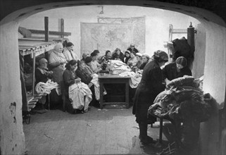 World war2, february 1942, defense of sevastopol, women sewing underwear and warm clothing for defenders of the town in a bomb shelter.