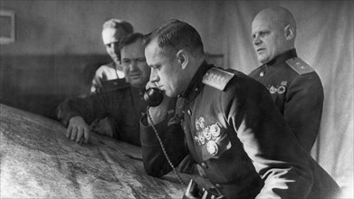 General konstantin rokossovsky, commander of the first byelorussian front, on the phone prior to the battle for stalingrad, on the right is lieutenant general telegin, member of the military council o...
