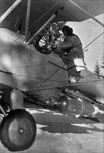 World war 2, soviet pilot preparing for a bombing run in a polikarpov po-2 (u-2) plane, ukraine.