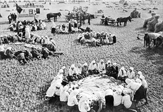 Dinner time during harvest season on a collective farm in russia, 1938.