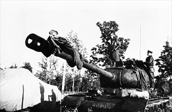 The boiko's tank unit receives new js-122 (joseph stalin 122) heavy tanks, 1942, tank commander,  junior lieutenant alexandra boiko watches the gun-layer, guards' sargeant russkikh, don the gun tarpau...