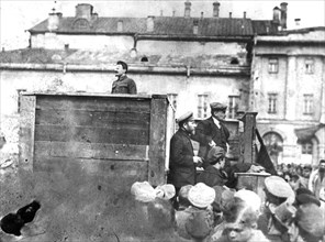 Leon trotsky addressing troops on their way to the polish front (civil war period), may 5th 1920, sverdlov square, moscow, on the stairs behind the speakers' platform are lev kamenev (in peaked cap) a...