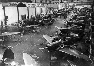 Yak-1 fighter planes being built in the assembly shop of a soviet aircraft factory during world war ll.