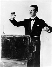 Lev termin (leon theremin) playing the musical synthesizer he invented, the termenvox (theremin), 1930s.