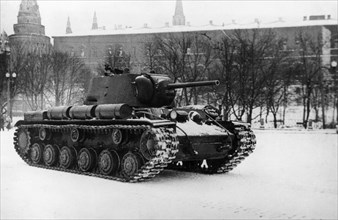 A soviet kv1 tank damaged in battle passing the moscow kremlin on the way back to the front after repairs, world war 2, ussr.