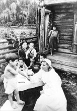 Doctor visits her patient, the child of a farmer in the ust-kabarzin district, gornaya shoria, siberia, ussr, late 1930s.