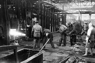 Workers of the krasny oktyabr iron and steel works back at work at the restored plant in stalingrad, ussr, 1940s.