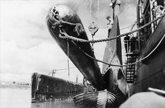 Black sea fleet, a torpedo being loaded onto a submarine during world war 2, august 1943.