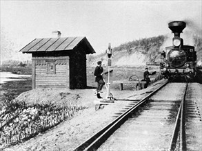The first train travelling by lake baikal along the trans-siberian railroad in russia in 1900.