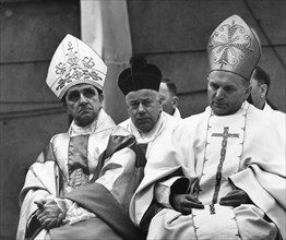 Cardinal karol wojtyla (later pope john paul 2) archbishop of cracow, poland (right), left: archbishop adam kozlowiecki from zambia, at eremonies to commemorate 25th anniversary of liberation of dacha...