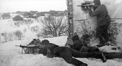 world war ll: red army men firing at fascist automatic riflemen, who fortified themselves in the houses of the village (southern front) in 1942.